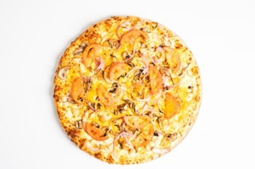 Round pizza with mushrooms, tomatoes, and onions on a white background.